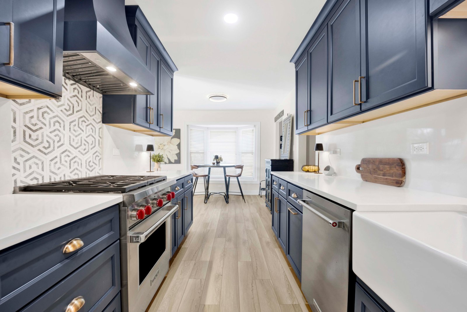 Open concept kitchen with custom lighting by Turn Key Designs